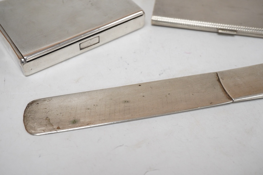 An engine turned 800 standard white metal cigarette case, 12cm, a 1920's Russian 875 standard white metal cigarette case and a white metal paper knife or page turner.